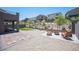 This backyard has stone tiles, gravel, Adirondack chairs near a fire pit, green grass, and a sitting area at 9451 Lunar Ray St, Las Vegas, NV 89143