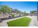 Spacious backyard with artificial turf, gravel landscaping, and a cozy fire pit area at 9451 Lunar Ray St, Las Vegas, NV 89143