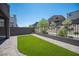 The backyard features artificial turf, decorative stone, and wrought iron fencing at 9451 Lunar Ray St, Las Vegas, NV 89143