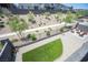 Well-manicured backyard with an artificial grass patch and a gravel fire pit, perfect for outdoor enjoyment at 9451 Lunar Ray St, Las Vegas, NV 89143