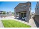 Rear view of a home showcasing a patio, fenced yard, and an inviting outdoor seating area at 9451 Lunar Ray St, Las Vegas, NV 89143