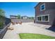 Spacious backyard featuring gravel landscaping, artificial turf, and a charming fire pit area at 9451 Lunar Ray St, Las Vegas, NV 89143
