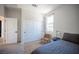 Bright, minimalist bedroom with a comfortable bed, window views, and a functional closet, maximizing space and comfort at 9451 Lunar Ray St, Las Vegas, NV 89143