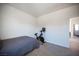 A simple bedroom provides a functional space with ample natural light and minimalist decor at 9451 Lunar Ray St, Las Vegas, NV 89143