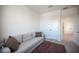 Cozy bedroom featuring a comfortable sofa, soft lighting, and neutral decor at 9451 Lunar Ray St, Las Vegas, NV 89143