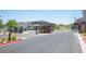 Community entrance features a secure gate, well-maintained landscaping, and neighborhood homes visible beyond at 9451 Lunar Ray St, Las Vegas, NV 89143