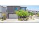 Modern two-story home with a two-car garage and landscaped front yard in a residential neighborhood at 9451 Lunar Ray St, Las Vegas, NV 89143