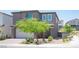 Modern two-story home with a two-car garage and landscaped front yard in a residential neighborhood at 9451 Lunar Ray St, Las Vegas, NV 89143