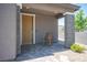 Cozy front porch with brick pillars, pavers and a rocking chair, creating an inviting entrance at 9451 Lunar Ray St, Las Vegas, NV 89143