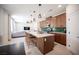 Open kitchen with a large island, wooden cabinets, stylish backsplash, and stainless steel appliances at 9451 Lunar Ray St, Las Vegas, NV 89143