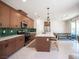 Modern kitchen boasts stainless appliances, green backsplash, large island and an adjacent dining area at 9451 Lunar Ray St, Las Vegas, NV 89143