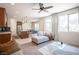 Bright living room features large windows, neutral decor, comfortable seating, and seamless flow to kitchen at 9451 Lunar Ray St, Las Vegas, NV 89143