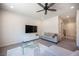 Bright living room features large windows, a ceiling fan, and comfortable seating at 9451 Lunar Ray St, Las Vegas, NV 89143