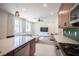 Bright and airy living space adjacent to the kitchen features neutral tones and ample natural light at 9451 Lunar Ray St, Las Vegas, NV 89143