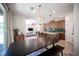 Open-concept living space with a kitchen island, dining table, and view of the cozy living room at 9451 Lunar Ray St, Las Vegas, NV 89143
