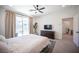 Bright main bedroom with neutral paint, carpet, and balcony access at 9451 Lunar Ray St, Las Vegas, NV 89143