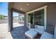 Cozy covered patio with comfortable seating, brick pavers, and access to a landscaped yard at 9451 Lunar Ray St, Las Vegas, NV 89143