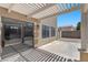 View of backyard featuring covered patio with slider doors and desert landscaping at 9625 Gatesville Ave, Las Vegas, NV 89148