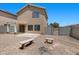 Backyard with gravel, concrete patio, pergola, privacy fence, and two benches for outdoor seating at 9625 Gatesville Ave, Las Vegas, NV 89148