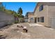 Gravel backyard featuring concrete patio, pergola, privacy fence, benches, and desert landscaping at 9625 Gatesville Ave, Las Vegas, NV 89148