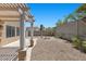 Backyard featuring pergola, concrete patio, gravel ground, landscaping, and a privacy fence at 9625 Gatesville Ave, Las Vegas, NV 89148