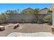 Backyard featuring privacy wall, desert landscaping, two benches, and a concrete patio at 9625 Gatesville Ave, Las Vegas, NV 89148
