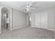 Neutral bedroom featuring a ceiling fan, carpeted floor, and closet with sliding doors at 9625 Gatesville Ave, Las Vegas, NV 89148
