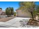 Cozy one story house featuring a two car garage, small landscaped yard, and a concrete driveway at 9625 Gatesville Ave, Las Vegas, NV 89148