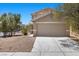 Two story home with a two car garage, neutral stucco exterior, and low maintenance desert landscaping at 9625 Gatesville Ave, Las Vegas, NV 89148