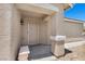 Inviting entryway featuring a security door, front porch bench, and neutral stucco exterior at 9625 Gatesville Ave, Las Vegas, NV 89148