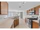 Kitchen showcasing stainless steel appliances, light countertops, and a view into the adjacent living area at 9625 Gatesville Ave, Las Vegas, NV 89148