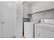 Laundry area featuring a washer and dryer, and white storage shelving at 9625 Gatesville Ave, Las Vegas, NV 89148