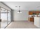 Living room view from kitchen, featuring tile floor, sliding glass doors, and lighting fixture at 9625 Gatesville Ave, Las Vegas, NV 89148