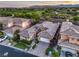 Gorgeous aerial view of the property, showcasing the lush green landscaping and well-maintained surroundings at 9733 Plateau Heights Pl, Las Vegas, NV 89144