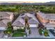 A stunning aerial view showcases this property's prime location overlooking a golf course and mountain range at 9733 Plateau Heights Pl, Las Vegas, NV 89144