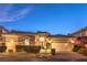 Charming home exterior featuring a manicured lawn and an attached two-car garage at 9733 Plateau Heights Pl, Las Vegas, NV 89144