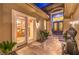 Elegant front entrance with tiled patio, double doors, and a tranquil water feature at 9733 Plateau Heights Pl, Las Vegas, NV 89144
