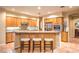 Well-equipped kitchen with wooden cabinets, granite countertops, and a breakfast bar with seating at 9733 Plateau Heights Pl, Las Vegas, NV 89144