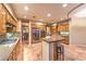 Modern kitchen featuring stainless steel appliances, granite counters, wooden cabinets, and tile flooring at 9733 Plateau Heights Pl, Las Vegas, NV 89144