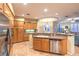 Open kitchen view with stainless steel appliances, granite counters, wooden cabinets, and tile flooring at 9733 Plateau Heights Pl, Las Vegas, NV 89144