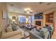 Inviting living room featuring a fireplace, ceiling fan, comfortable seating, and natural light at 9733 Plateau Heights Pl, Las Vegas, NV 89144