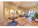 Spacious living room showcasing beautiful tile floors, archways, and access to the outdoor area at 9733 Plateau Heights Pl, Las Vegas, NV 89144