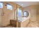 Main bath featuring a glass shower, soaking tub, and decorative tile at 9733 Plateau Heights Pl, Las Vegas, NV 89144