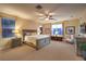 Spacious main bedroom features a king-sized bed, soft carpet, and large windows for ample natural light at 9733 Plateau Heights Pl, Las Vegas, NV 89144