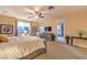 Bright main bedroom with plush carpet, an en-suite bath, and access to outdoor patio at 9733 Plateau Heights Pl, Las Vegas, NV 89144