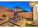 Private patio with stone pavers, seating area, and lush landscaping provides a relaxing outdoor space at 9733 Plateau Heights Pl, Las Vegas, NV 89144