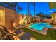 Backyard view of the refreshing pool with relaxing lounge chairs and manicured landscaping at 9733 Plateau Heights Pl, Las Vegas, NV 89144