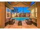 Inviting pool area with well-manicured landscaping, comfortable seating and palm trees at 9733 Plateau Heights Pl, Las Vegas, NV 89144