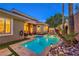 Inviting backyard oasis with a sparkling pool, lush landscaping, and a cozy lounge area at 9733 Plateau Heights Pl, Las Vegas, NV 89144
