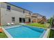 Beautiful backyard features a sparkling pool and well-maintained artificial grass, creating a relaxing outdoor space at 10161 Bismarck Palms Ave, Las Vegas, NV 89166